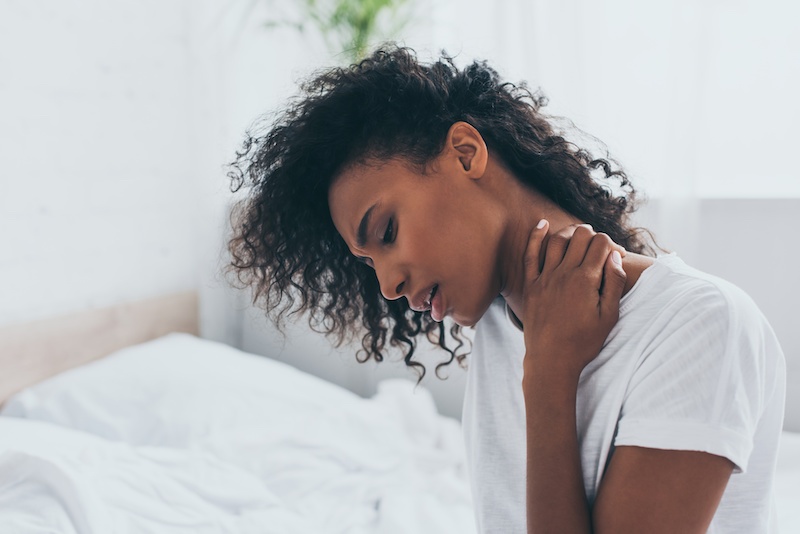 woman with pain in her neck and back