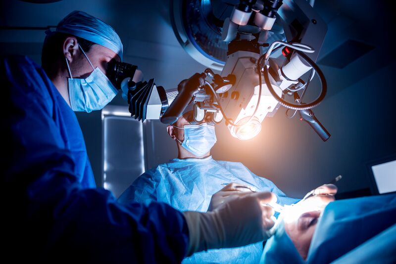 doctors performing brain surgery on patient